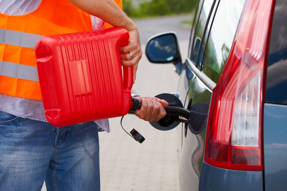 Man filling a gas tank from a jerry can